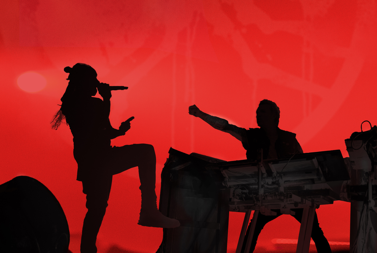 The Prodigy standing in front of red background 